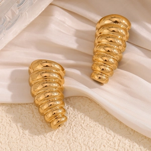 Detailed close-up of 18K gold plated stainless steel spiral earrings on white silk