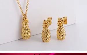 Detail view of a gold-plated titanium steel pineapple necklace and stud earrings jewelry set