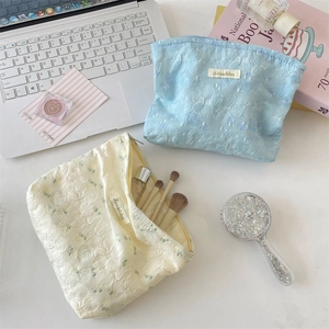 Macro shot of large capacity jacquard rose makeup bags with textured floral details