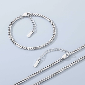 Detail of silver stainless steel Cuban chain with lobster clasp and S.Steel engraved tag