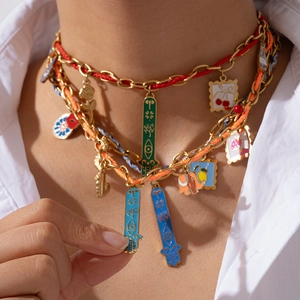 Detailed close-up of Bohemian layered necklace with gold chains and colorful enamel charms