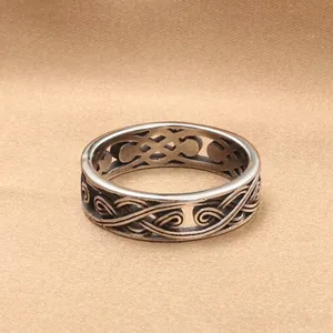 Retro punk hollow celtic pattern stainless steel ring for men on fabric background