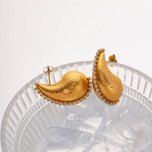 Chubby 18K gold teardrop earrings with zircons displayed on ice for a luxury look