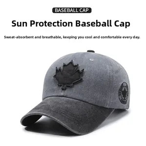Detail of maple leaf embroidery on washed cotton baseball cap with vintage distressed texture