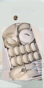 Ceramic tableware set in cream white organized neatly in a storage rack