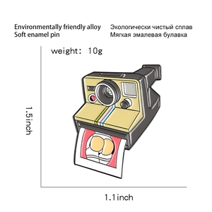Detail view of cartoon polaroid camera enamel pin with alloy material specifications