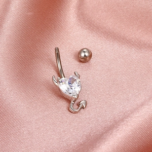 Silver devil heart belly button ring with clear zircon on pink silk fabric background