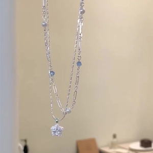 Double-layered necklace with star pendant, cubic zirconia, and mixed pearl beads
