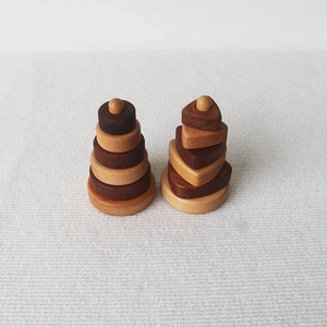 Rainbow stacking tower wooden toys with round and heart shapes on beige woven surface