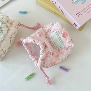 Detail of quilted floral drawstring bags for cameras with soft padding and cotton fabric