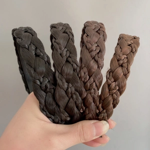 Detailed view of hand-woven fishtail braid headbands in four natural brown shades