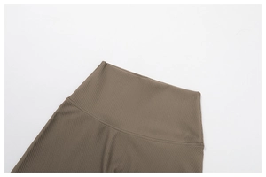 Detail of high waist ribbed yoga pants showing fine stitching in coffee brown fabric