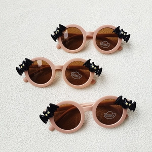 Pink bat-shaped kids sunglasses with UV400 protection and round lenses for fashion wear