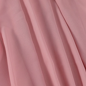 Macro detail of pleated bubble chiffon fabric in elegant dusty rose pink texture