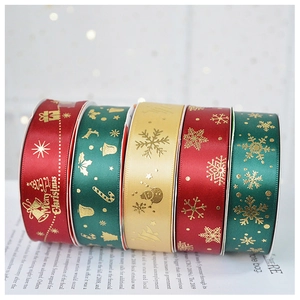 Detail of Christmas satin ribbons with gold foil snowflakes and Merry Christmas lettering