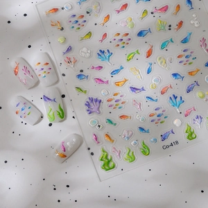 Detailed view of 3D embossed tropical fish nail stickers with coral and bubble patterns