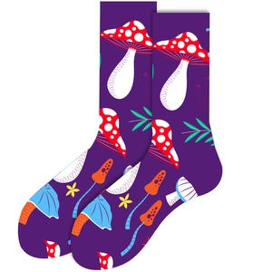 Detail of purple socks featuring vibrant mushroom, leaf, and floral patterns in a flat lay view