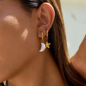 18K gold-plated star and crescent moon pearl hoop earrings shown on a model