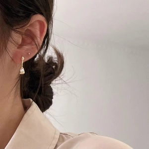 Elegant 925 silver irregular pearl drop earrings worn by a model in soft light
