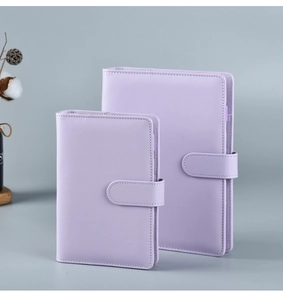 Detail view of purple PU leather notebooks in two sizes with secure magnetic snap closures