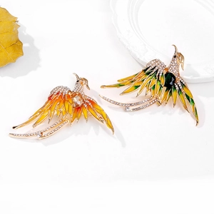 Detail of colorful enamel phoenix brooches with sparkling rhinestones and gemstones