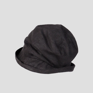 Close-up detail of a breathable black linen blend bucket hat with natural textured fabric