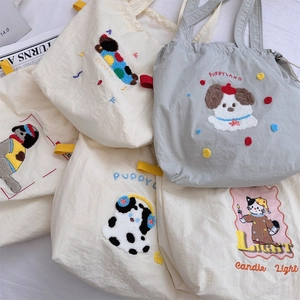 Detail of cute cartoon animal embroidery on Korean canvas tote bags with soft textures