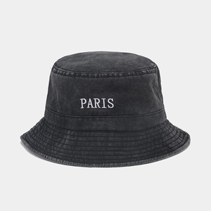 Detailed close-up of Paris embroidery on washed black cotton denim bucket hat