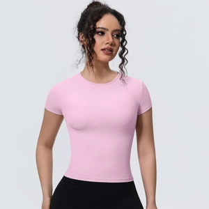 Close-up of slim-fit pink yoga t-shirt featuring high-stretch breathable fabric details