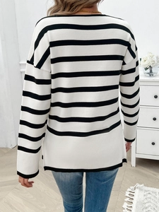 Rear view of long-sleeved black and white striped knit sweater with ribbed cuffs and hemline