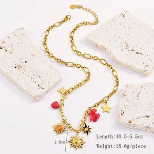 Detailed view of gold multi-element sunflower and heart necklace on a stone stand
