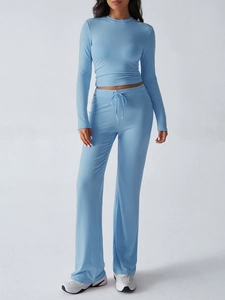 Women's blue Y2K long sleeve cropped top and wide leg trousers set on white background