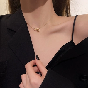 Minimalist double interlocking heart and ring necklace in polished golden stainless steel