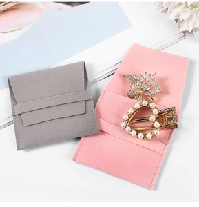 Pink and gray microfiber jewelry pouches with gold crystal brooch and pearl hair clip