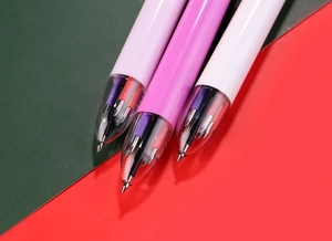 Macro shot of transparent pen tips showing multi-color ink refills and plastic barrel