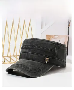Detail of washed cotton cadet cap featuring reinforced stitching and metal shield emblem