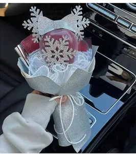 Close-up of a Christmas apple gift bouquet with silver snowflake and glitter wrapping