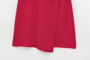 Detailed macro view showing the double-layered hem stitching of the red sleeveless romper