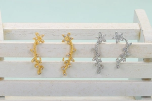 Sparkling sunflower climbing earrings in gold and silver finish with crystal vine details