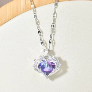 Detail of the blue-purple gradient heart crystal pendant with silver wings on fine chain