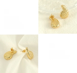 Détail de boucles d'oreilles goutte dorées martelées avec finition polie et placage