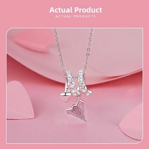 Detailed view of S925 silver necklace with pink paper plane and sparkling heart charms