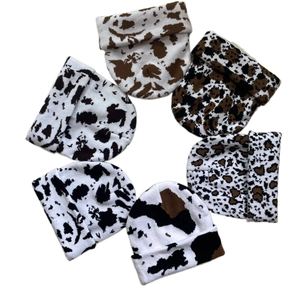 Close-up of assorted knit beanies with animal prints like cow and leopard patterns