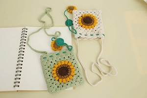 Detailed view of handmade crochet flower crossbody bags in beige and mint green colors