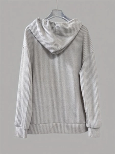 Close-up of gray ribbed texture fabric on long-sleeved hooded sweatshirt with dropped shoulders