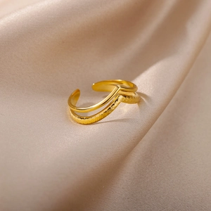 Macro shot of 18k gold double-layered V-shaped ring with polished and textured finish