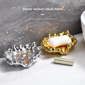 Polished gold and silver irregular ripple trays for jewelry and soap on marble