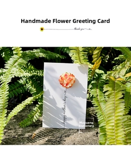 Detail of handmade Mother's Day card with 3D orange flowers on natural stone background