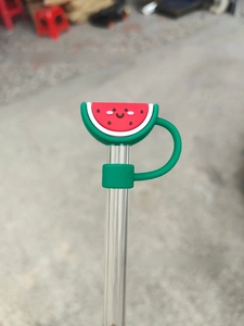 Detailed view of a cute watermelon silicone straw topper with protective dust cap design