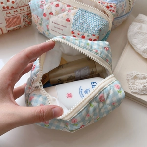 Quilted floral makeup bag interior showing large capacity for daily skincare products
